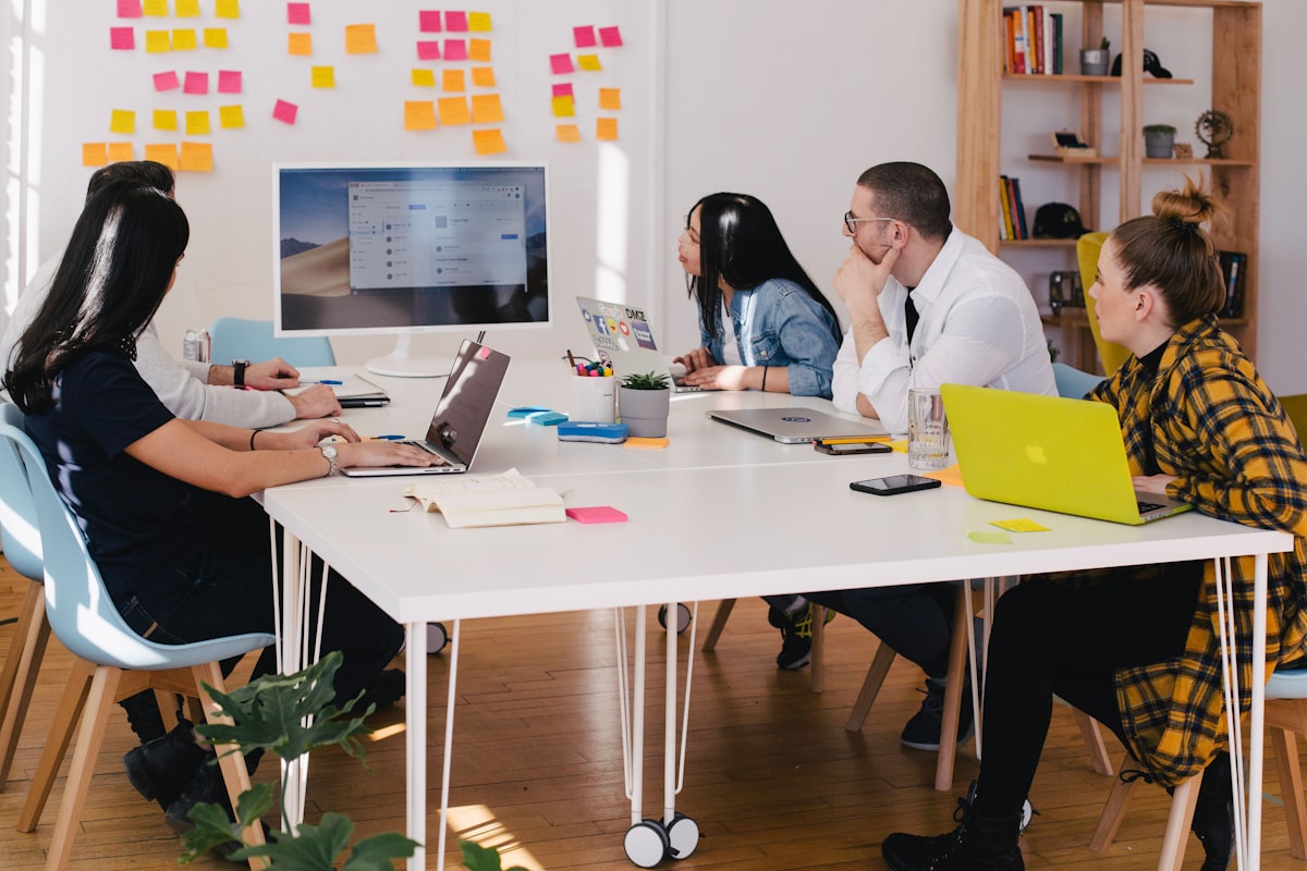 A cross-functional team gathered around a table during a project strategy session